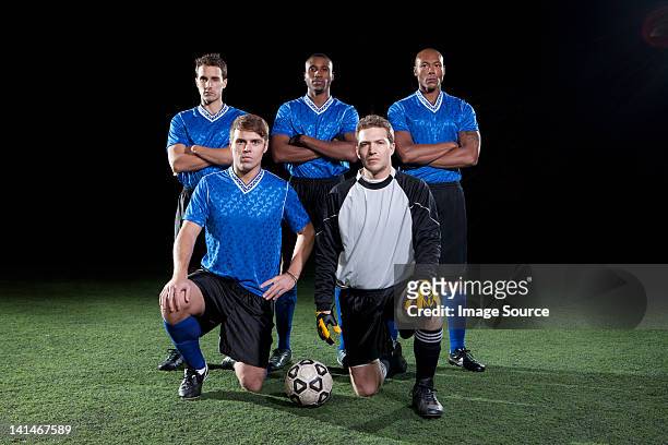 soccer team on pitch at night - soccer team stock pictures, royalty-free photos & images