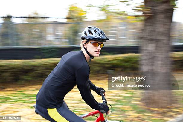 cyclist on the move - cycling vest stock pictures, royalty-free photos & images