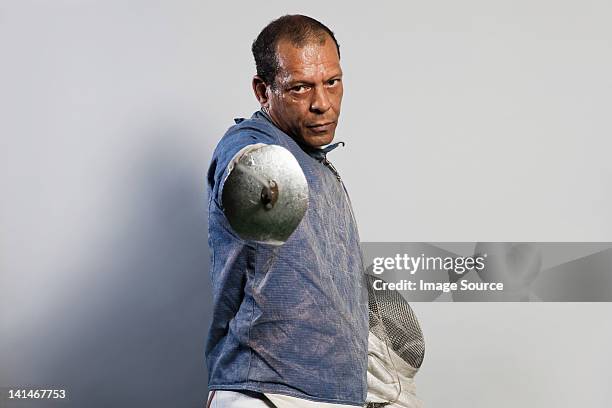 portrait of senior man in fencing suit - fencing sport stock pictures, royalty-free photos & images