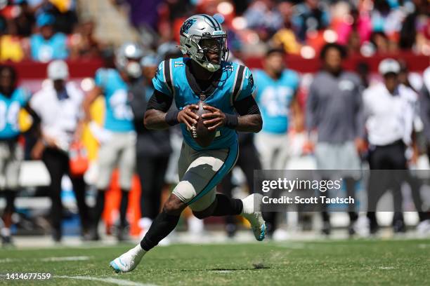 Walker of the Carolina Panthers scrambles against the Washington Commanders during the second half of the preseason game at FedExField on August 13,...