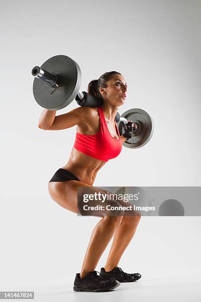 female weightlifter using barbell - weightlifting stock pictures, royalty-free photos & images