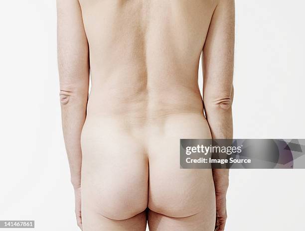 rear view of nude man - buttock stock-fotos und bilder