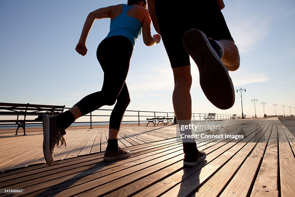 Two people running on promenade