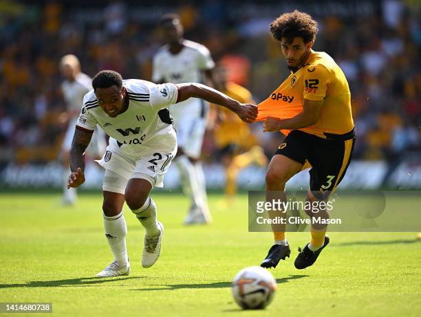 Kenny Tete of Fulham is challenged by Rayan Ait-Nouri of Wolverhampton Wanderers during the Premier League match between Wolverhampton Wanderers and...