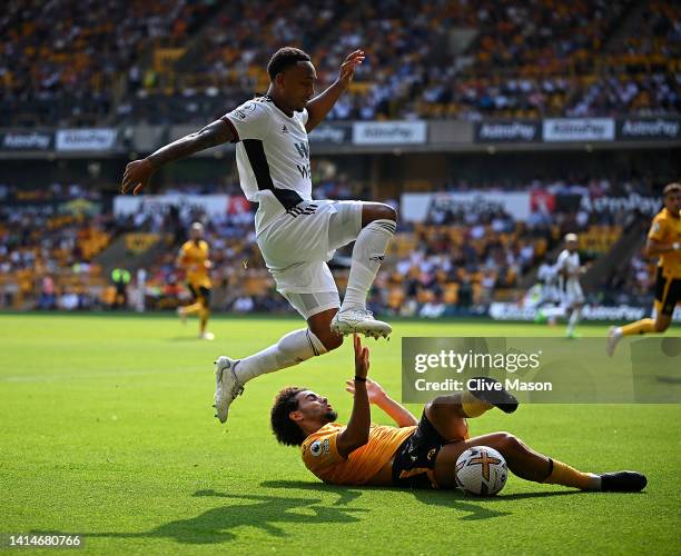 Kenny Tete of Fulham is challenged by Rayan Ait-Nouri of Wolverhampton Wanderers during the Premier League match between Wolverhampton Wanderers and...