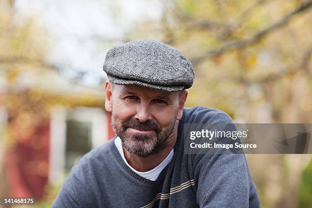 mature man in flat cap outdoors - platte pet stockfoto's en -beelden