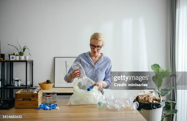 happy woman recycling garbage at home - packaging waste stock pictures, royalty-free photos & images