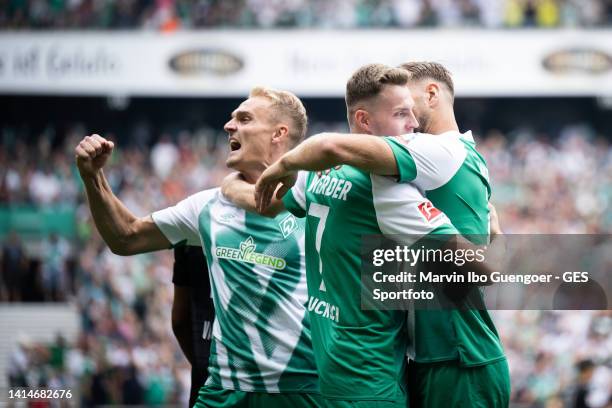 Niclas Fuellkrug celebrates after scoring his team's first goal with Amos Pieper and Marvin Duksch of Bremen during the Bundesliga match between SV...