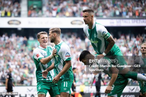 Niclas Fuellkrug celebrates after scoring his team's first goal with Amos Pieper, Anthony Jung and Marco Friedl of Bremen during the Bundesliga match...