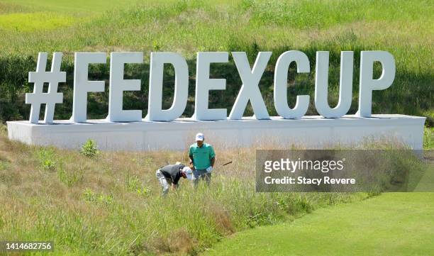 Kevin Kisner of the United States and Tyler Duncan of the United States look for a lost ball on the 13th hole during the third round of the FedEx St....