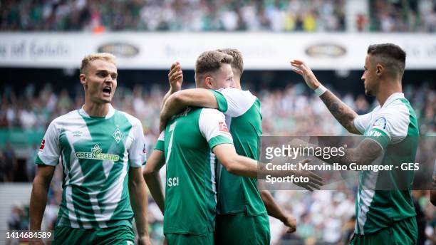 Niclas Fuellkrug celebrates after scoring his team's first goal with Amos Pieper, Marvin Duksch and Marco Friedl of Bremen during the Bundesliga...
