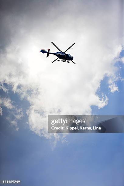 helicopter against sky, low angle view - police helicopter stock pictures, royalty-free photos & images