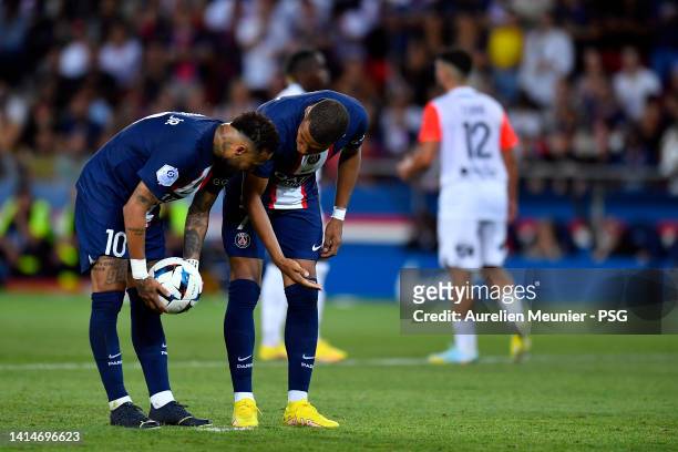 Neymar Jr and Kylian Mbappe of Paris Saint-Germain speak before a penalty kick during the Ligue 1 match between Paris Saint-Germain and Montpellier...