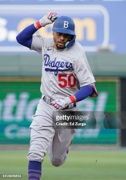 Mookie Betts of the Los Angeles Dodgers celebrates his home run in the first inning against the Kansas City Royals at Kauffman Stadium on August 13,...