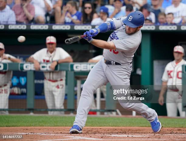 Max Muncy of the Los Angeles Dodgers hits a two-run single in the first inning against the Kansas City Royals at Kauffman Stadium on August 13, 2022...