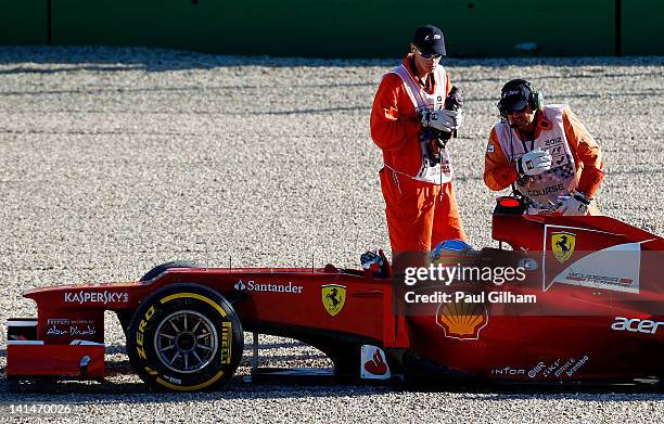 Fernando Alonso of Spain and Ferrari retires early after spinning out into gravel trap during qualifying for the Australian Formula One Grand Prix at...