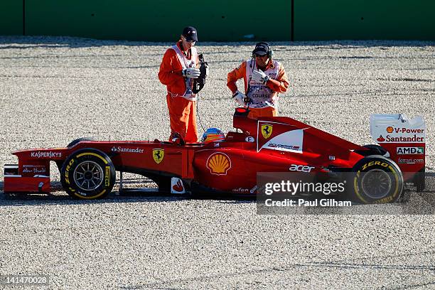 Fernando Alonso of Spain and Ferrari retires early after spinning out into gravel trap during qualifying for the Australian Formula One Grand Prix at...