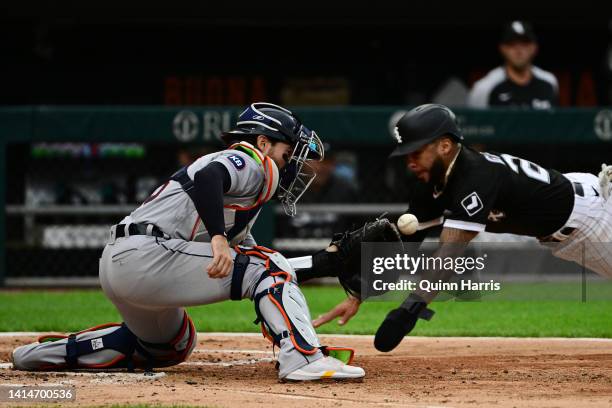 Leury Garcia of the Chicago White Sox beats the tag from Eric Haase of the Detroit Tigers to score in the second inning at Guaranteed Rate Field on...