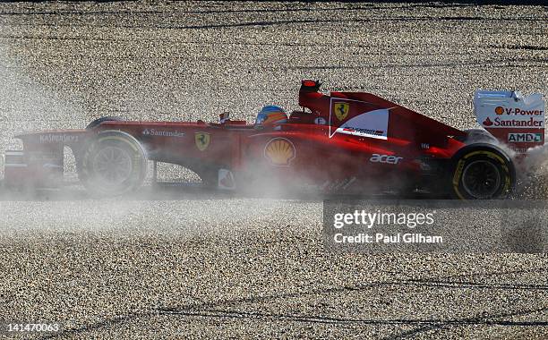 Fernando Alonso of Spain and Ferrari retires early after spinning out into gravel trap during qualifying for the Australian Formula One Grand Prix at...