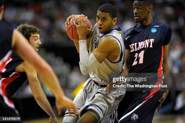 Georgetown Hoyas forward Hollis Thompson , center, drives through ,b1., left, and Belmont Bruins guard Ian Clark , right , as the Georgetown Hoyas...