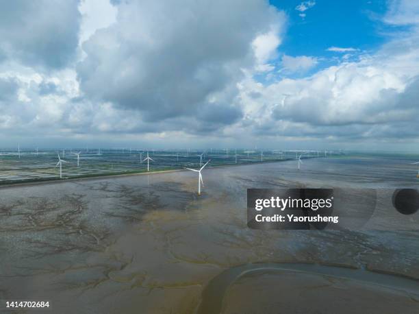 aerial view of the windmill plant at natural shapes tidal mudflats - wadden sea stock pictures, royalty-free photos & images