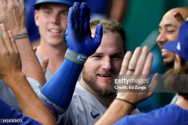 Max Muncy of the Los Angeles Dodgers is congratulated by teammates after hitting a two-run home run in the fourth inning against the Kansas City...