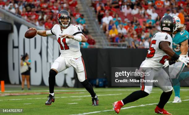 Blaine Gabbert of the Tampa Bay Buccaneers scrambles during a preseason game against the Miami Dolphins at Raymond James Stadium on August 13, 2022...