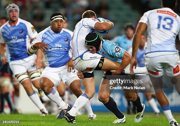 Berrick Barnes of the Waratahs tackles James Stannard of the Force during the round four Super Rugby match between the Waratahs and the Force at...