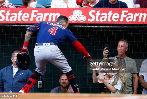 Carlos Correa of the Minnesota Twins celebrates a home run with his wife Daniella Rodriguez and son, Kylo in the first inning against the Los Angeles...