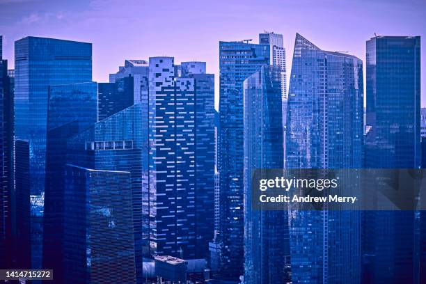 purple blue modern glass skyscraper, financial district - generic location stockfoto's en -beelden