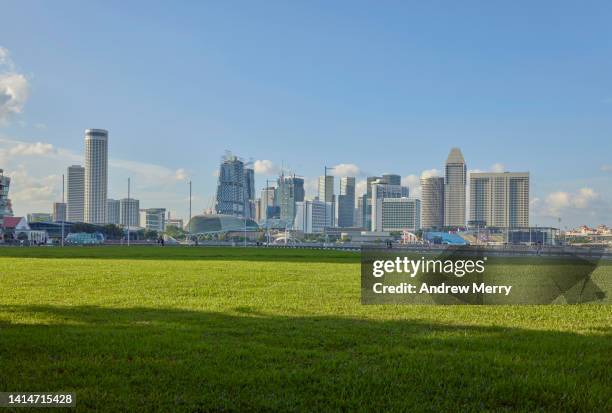 green grass park, reclaimed land, singapore city skyline - singapore city landscape stock pictures, royalty-free photos & images