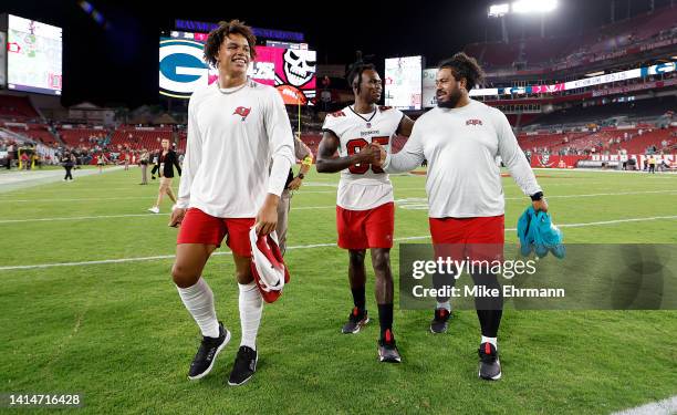 Joe Tryon-Shoyinka, Julio Jones and Vita Vea of the Tampa Bay Buccaneers walk off the field following a preseason game against the Miami Dolphins at...