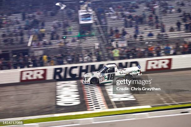 Chandler Smith, driver of the Charge Me Toyota, crosses the finish line to win the NASCAR Camping World Truck Series Worldwide Express 250 for...