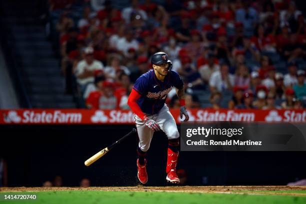Carlos Correa of the Minnesota Twins singles against the Los Angeles Angels in the ninth inning at Angel Stadium of Anaheim on August 13, 2022 in...