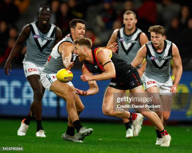 Dyson Heppell of the Bombers handballs under pressure during the round 22 AFL match between the Essendon Bombers and the Port Adelaide Power at...