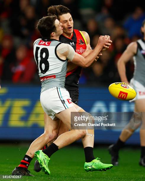 Archie Perkins of the Bombers is tackled by Zak Butters of the Power during the round 22 AFL match between the Essendon Bombers and the Port Adelaide...