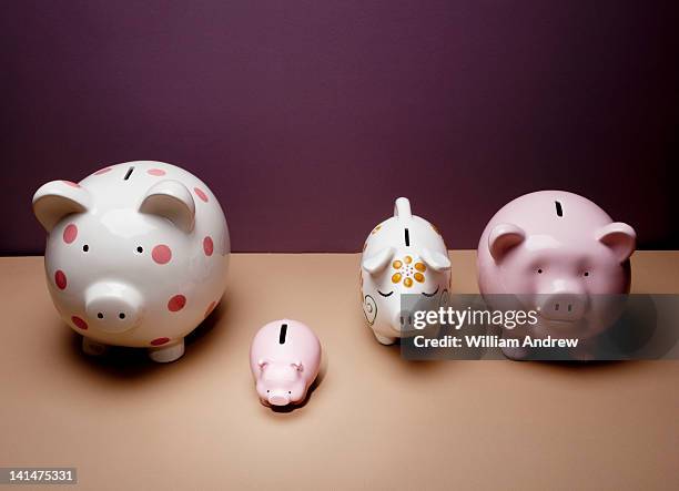 piggy bank standing out from row - polka dot piggy bank stock pictures, royalty-free photos & images