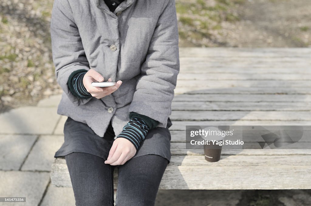 The woman using a smart phone, outside