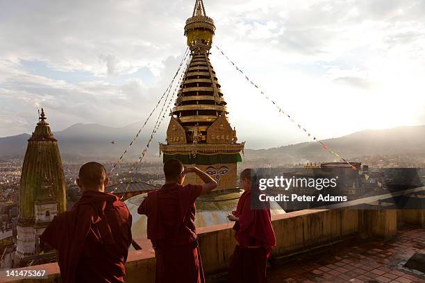 monks at swayambunath or monkey temple, kathmandu - swayambhunath stock pictures, royalty-free photos & images