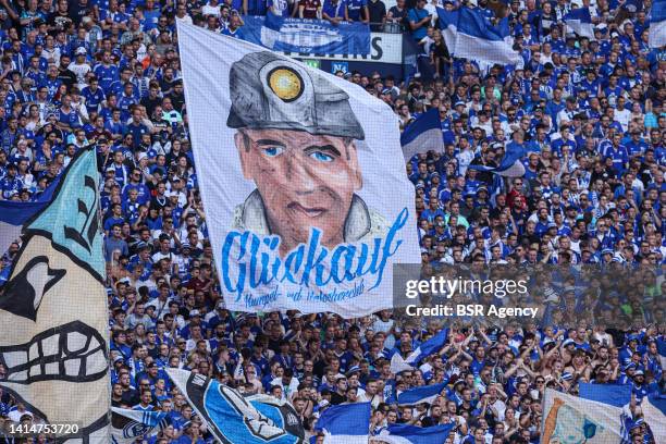 Fans of Schalke 04 with a flag during the German Bundesliga match between Schalke 04 and Borussia Monchengladbach at Veltins Arena on August 13, 2022...