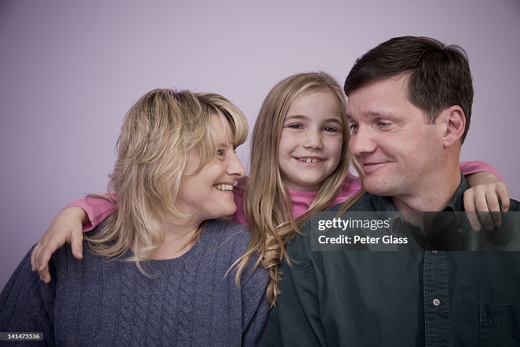 Middle-age couple with their young daughter.