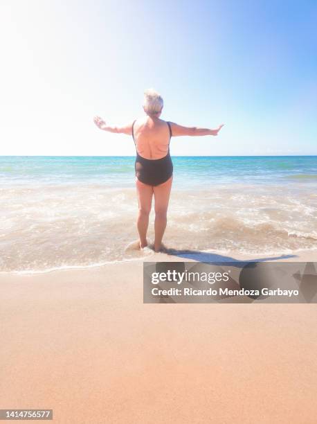 elderly lady on the beach - provincia de tarragona stock pictures, royalty-free photos & images