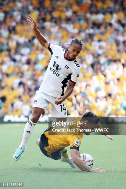 Pedro Neto of Wolverhampton Wanderers is challenged by Bobby De Cordova-Reid of Fulham during the Premier League match between Wolverhampton...
