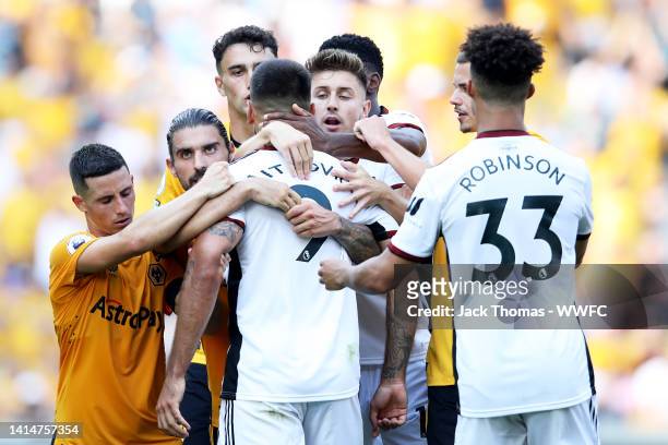 Aleksandar Mitrovic of Fulham is held back during the Premier League match between Wolverhampton Wanderers and Fulham FC at Molineux on August 13,...