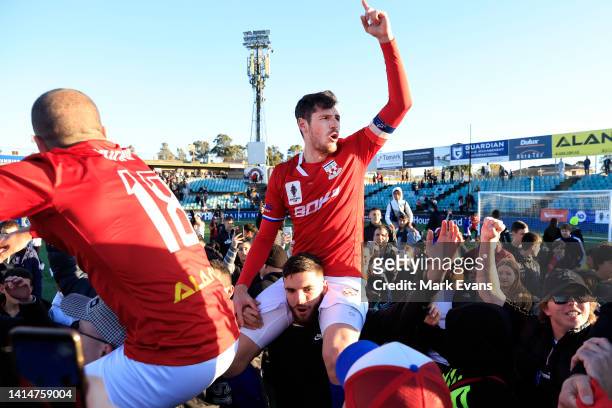 Sydney United players are mobbed by supporters after their victory during the Australia Cup Rd of 16 match between Sydney United 58 FC and Western...