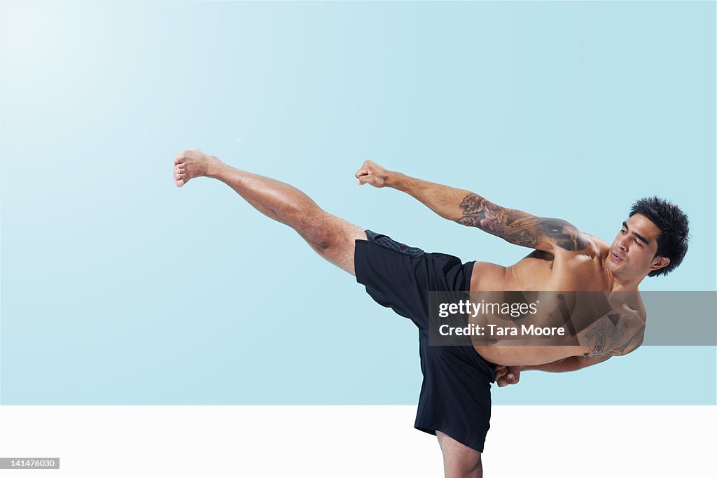 Taekwondo man punching and kicking