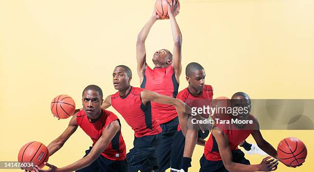 man playing basketball cloned several times - multiple images stock pictures, royalty-free photos & images