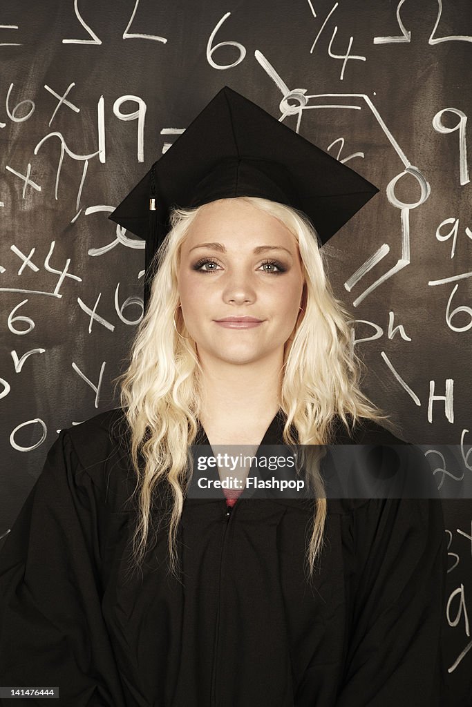 Portrait of woman wearing graduation cap and gown