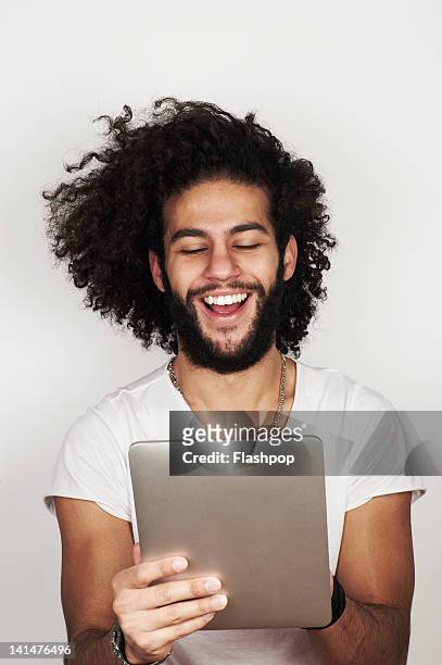 portrait of man using digital tablet - men long hair stock pictures, royalty-free photos & images