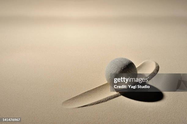 sphere of stone and  line is drawn in the sandpit - zen sand stock pictures, royalty-free photos & images